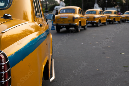 Local yellow taxi waiting for passengers in taxi stand near Victoria Memorial. Yellow taxi is oldest Taxi in Kolkata city and it is also a tourist attraction for ride.