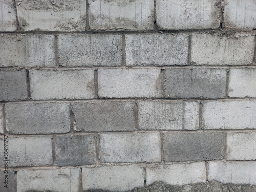 Texture of foam blocks. Gray, dark gray wall of blocks.