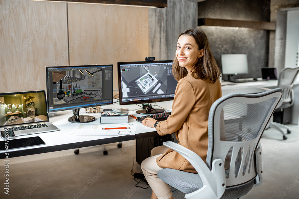 Portrait of a young creative office employee making interior design, 3d modeling on the computer while sitting at the modern office of architectural firm