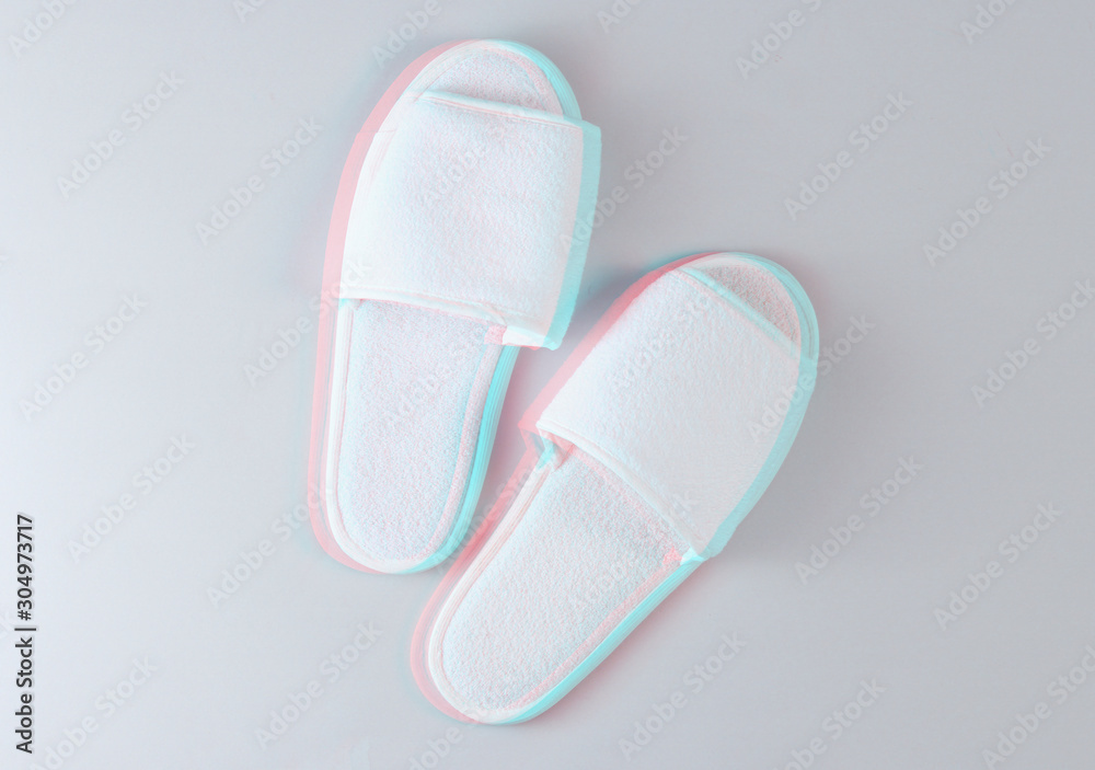 White hotel sleeping slippers on a gray background. Top view. Glitch effect White hotel sleeping slippers on a gray background. Top view. Glitch effect