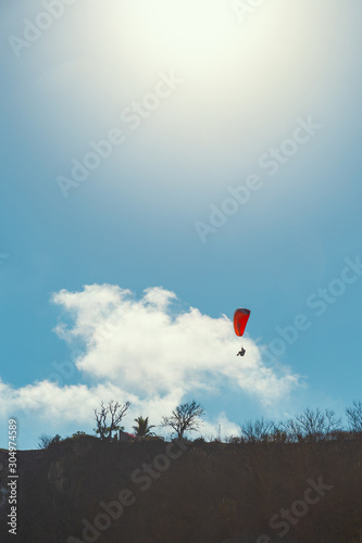 Paraglider and clear blue sky background