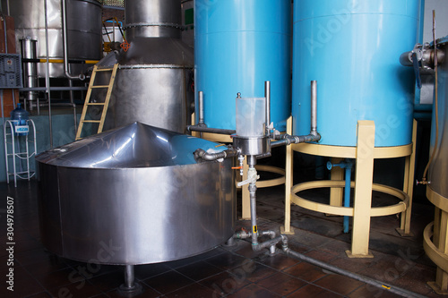 Industrial steel barrels. Alembic still for making alcohol distillery inside