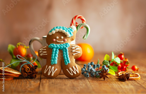Christmas gingerbread cookies with Christmas decorations on wooden background.