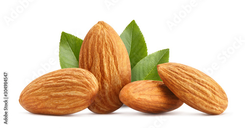 Close-up of delicious almonds with leaves, isolated on white background