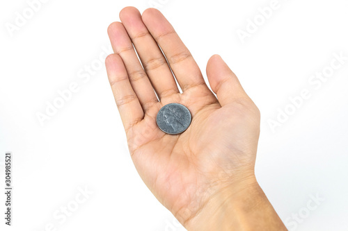 A coin placed on the hands of a man. Isolated on white background. Close up shot.