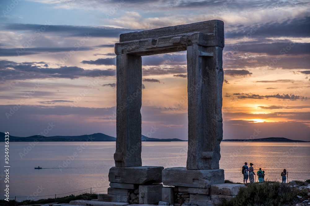 Fototapeta premium Portara - ruins of ancient temple of Delian Apollo on Naxos island at sunset, Cyclades archipelago, Greece.