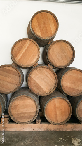 oak barrels of wine. Wooden wine barrels for storage in wine cellar.