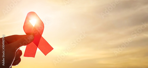 Red ribbon symbol of AIDS and HIV disease.