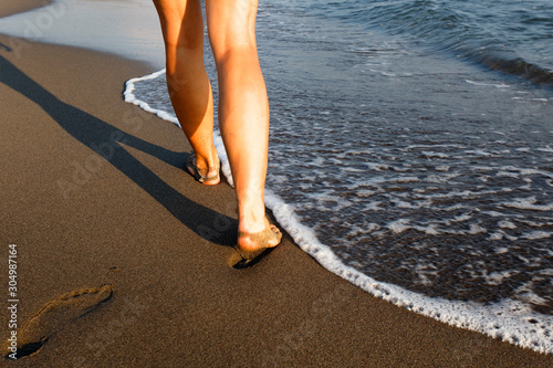 Girl walks on the sandy beach in Ada Bojana near Ulcinj photo