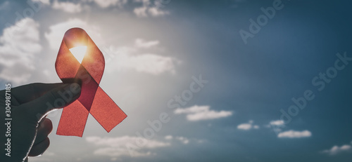 Red ribbon symbol of AIDS and HIV disease. photo