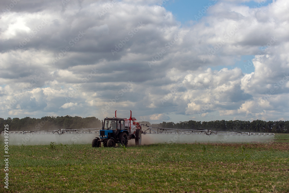 Fototapeta premium Ukraine, the tractor makes fertilizer