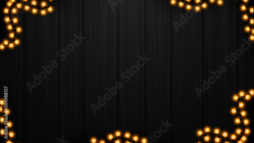 Black wood texture with yellow garland, background for your arts