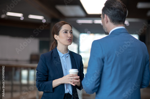 Canvas Print Business lady talking to her business partner while drinking coffee
