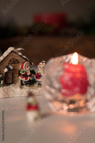 Christmas decoration, snowmen, candles and Santa Claus, light and shadow, selective focus