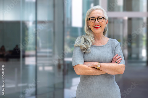 Fotografering Portrait of a confident mature business person standing outside office workspace