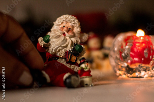 Christmas decoration, snowmen, candles and Santa Claus, light and shadow, selective focus