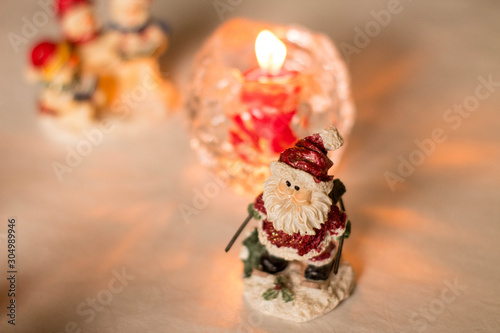 Christmas decoration, snowmen, candles and Santa Claus, light and shadow, selective focus