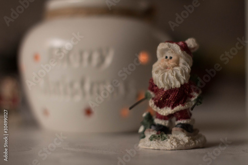 Christmas decoration, snowmen, candles and Santa Claus, light and shadow, selective focus
