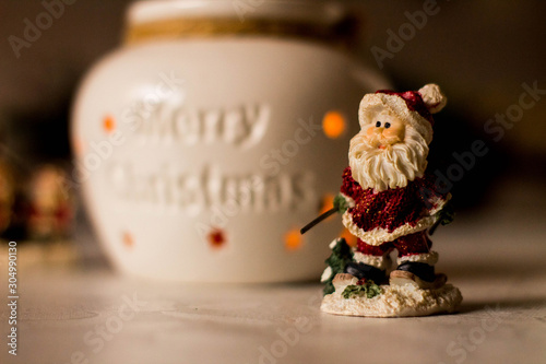 Christmas decoration, snowmen, candles and Santa Claus, light and shadow, selective focus