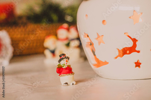 Christmas decoration, snowmen, candles and Santa Claus, light and shadow, selective focus