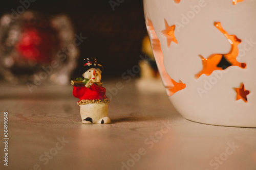 Christmas decoration, snowmen, candles and Santa Claus, light and shadow, selective focus