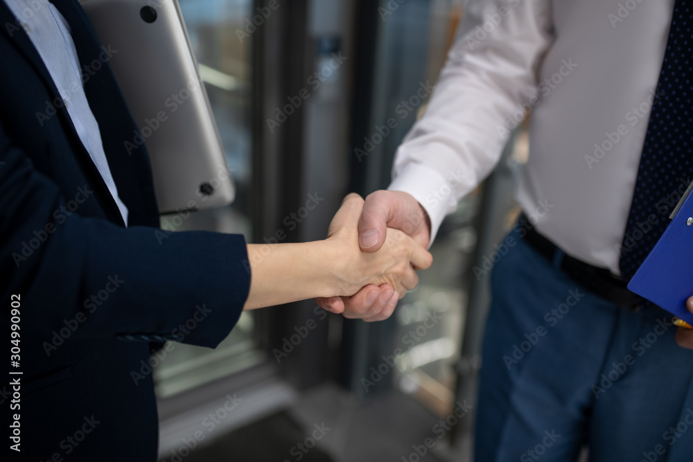 Close up of businesswoman shaking hand of her business partner Close up of businesswoman shaking hand of her business partner