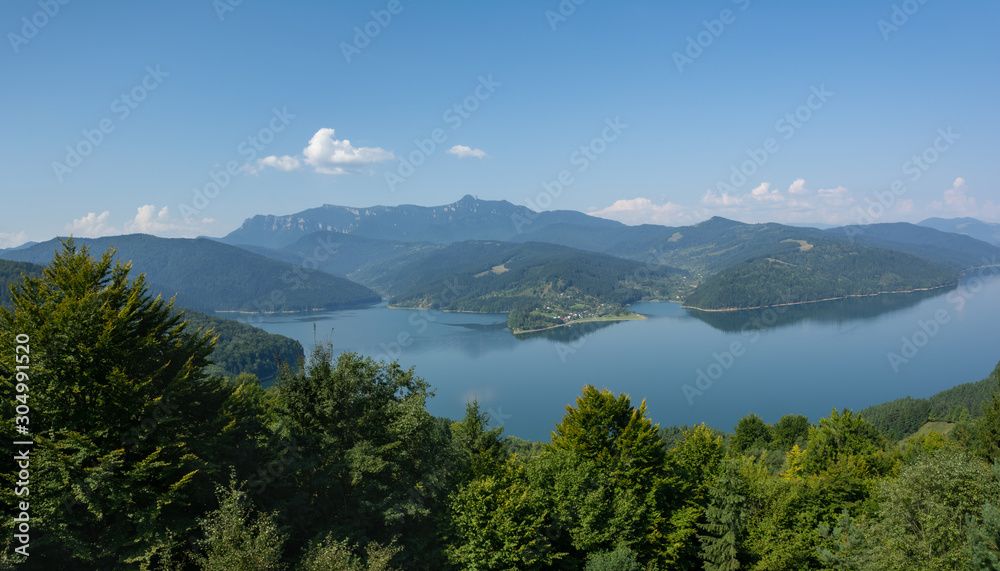 View of Lake Izvorul Muntelui and Massif Ceahlau on the background, Romania