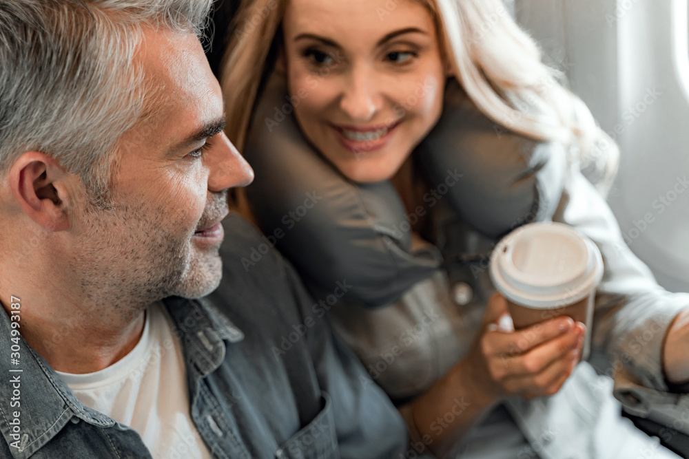 Smiling young woman is looking at man in cabin Smiling young woman is looking at man in cabin