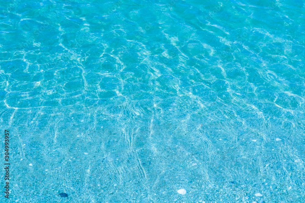 The water is so clear that you can see the sand and shells in the water