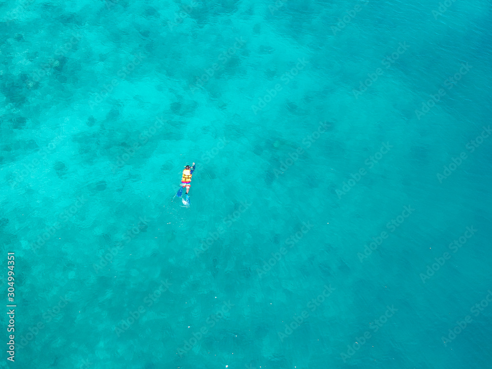 Fototapeta premium Top view Man snorkeling on nature beautiful blue ocean 