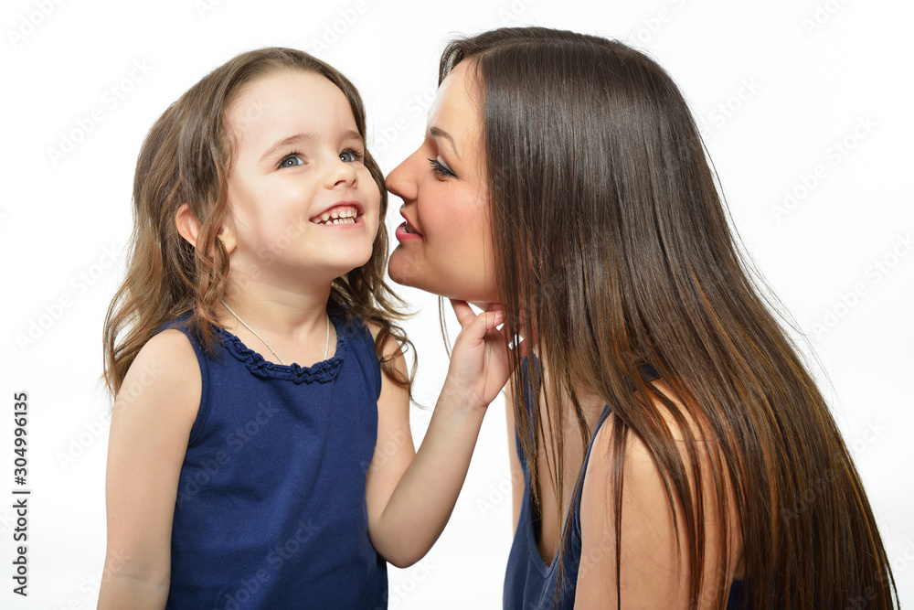 Mother and daughter. Portrait of little girl with her mother over white background. Mother and daughter. Portrait of little girl with her mother over white background.