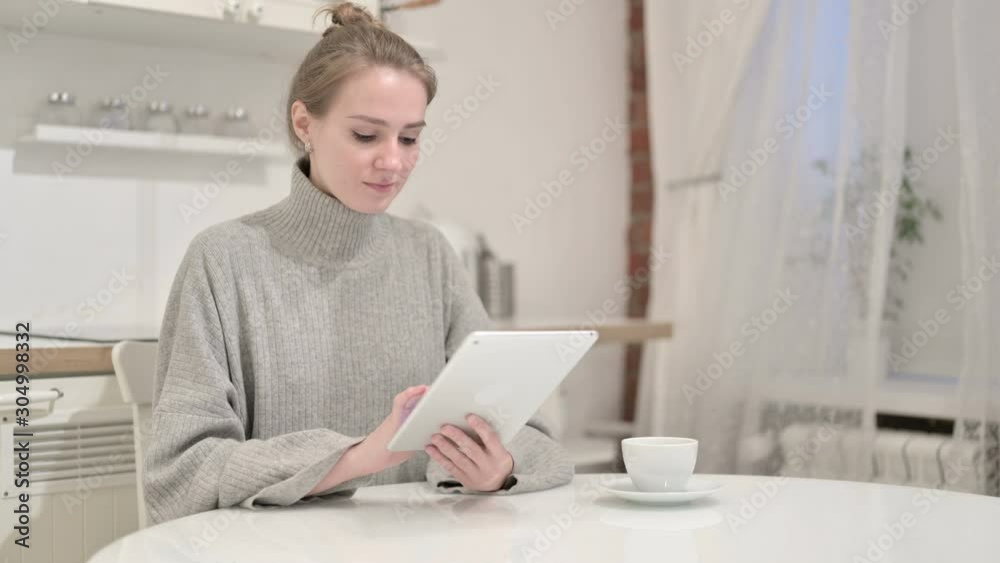 Hardworking Young Woman using Tablet at Home Hardworking Young Woman using Tablet at Home
