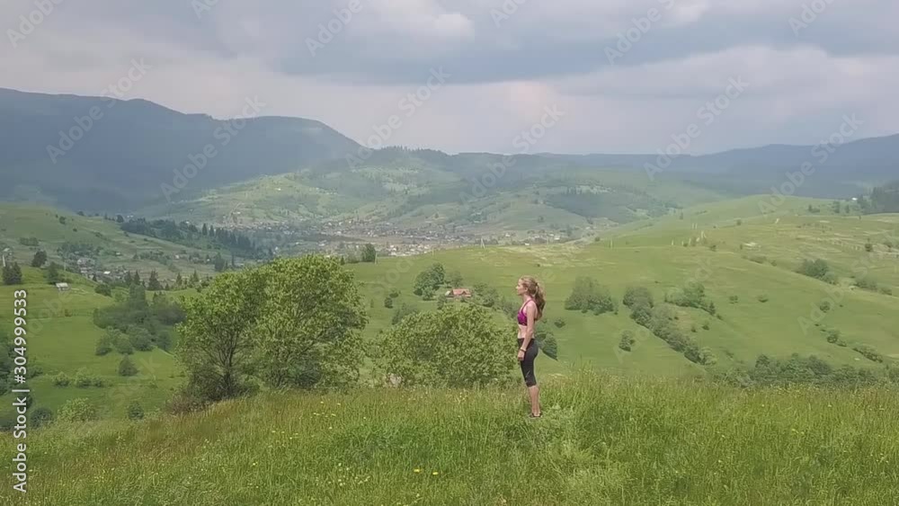 Young woman enjoying mountain view on a summer day. Relax and meditation in nature environment. Young woman enjoying mountain view on a summer day. Relax and meditation in nature environment.