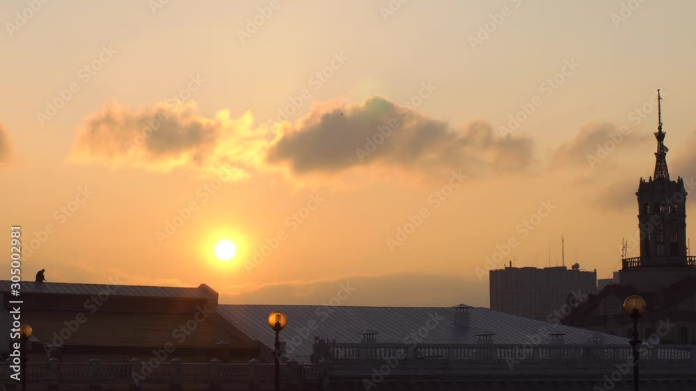 man walks on the roof against the backdrop of a beautiful sunset man walks on the roof against the backdrop of a beautiful sunset