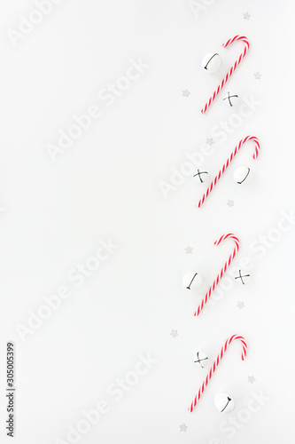 Christmas Background with Jingle Bells, Candy Canes and Stars on White