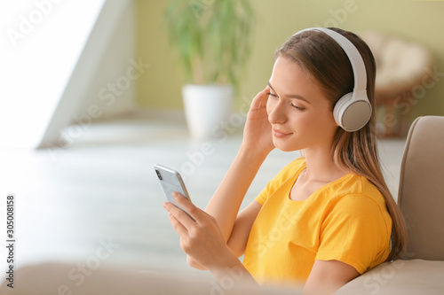 Young woman listening to music at home