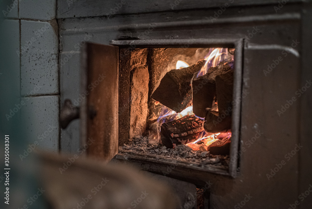 Fire burns in an old wood-burning stove in a rural house Stock Photo |  Adobe Stock