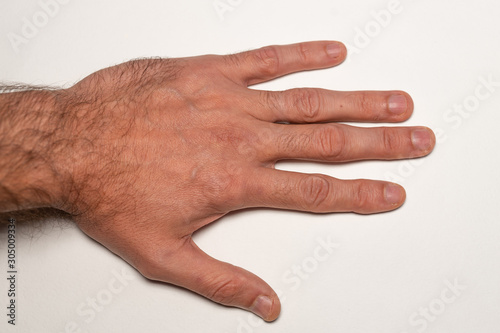 Male hairy hand close up, top view