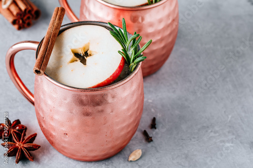 Photography Apple Cider Moscow Mule cocktail with cinnamon stick and rosemary in copper