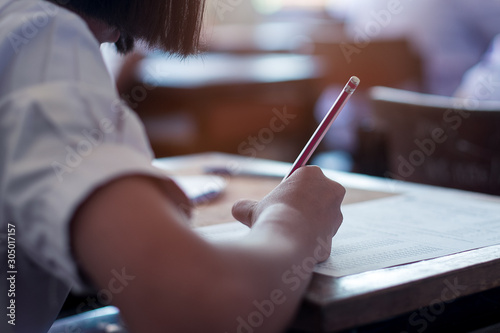 Student taking exam with stress in school classroom