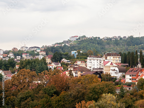 Private houses on a background of beautiful autumn trees