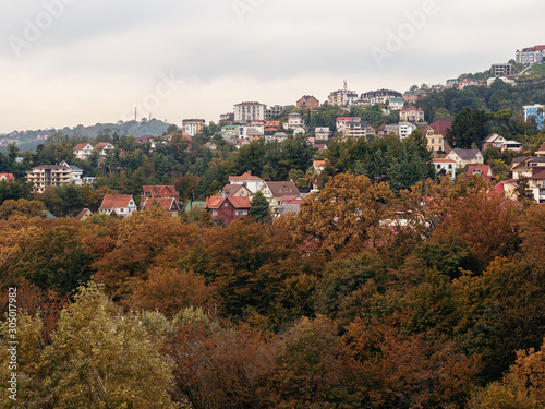 Private houses on a background of beautiful autumn trees