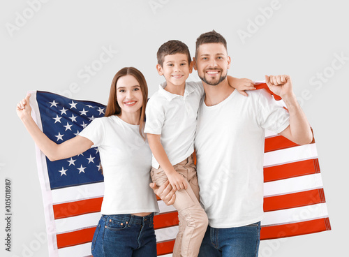 Family with USA flag on lig...