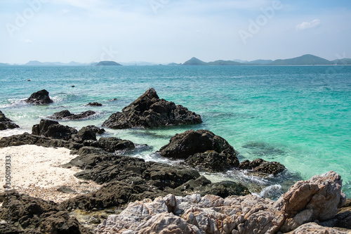 Beach, black rock And the clear sea water on Kham island or Koh Kham, Thailand
