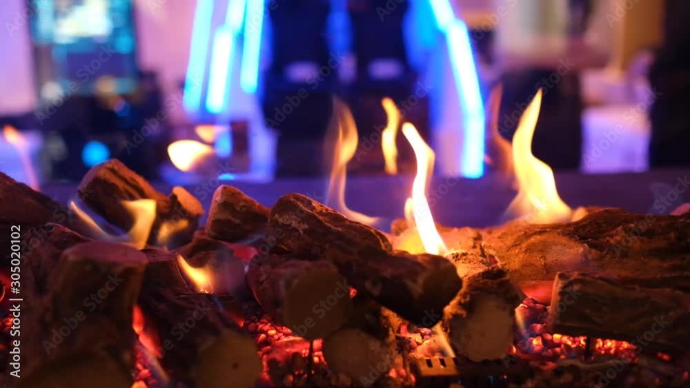 Close up of fire flames in a modern fireplace with burning wood, indoor ...