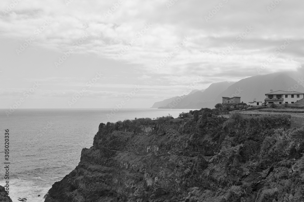 A village with white buildings on a cliff in the Atlantic Ocean (Seixal, Madeira, Portugal)