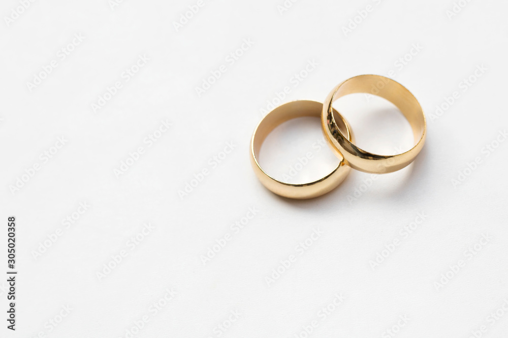 two golden wedding rings isolated on white, wedding rings background concept two golden wedding rings isolated on white, wedding rings background concept