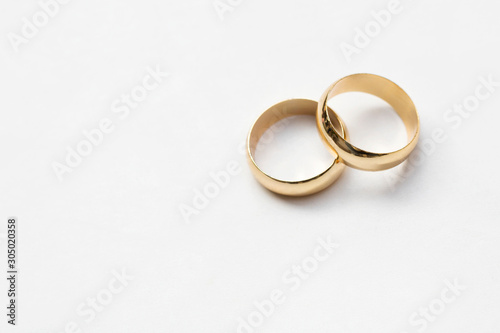two golden wedding rings isolated on white, wedding rings background concept