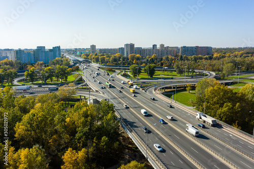 Aerial shot of a big freeway intersection in Warsaw, traffic going fast through many road flyovers. Warsaw, Poland. 