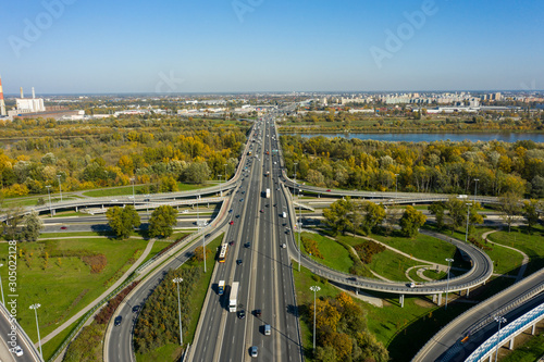 Aerial shot of a big freeway intersection in Warsaw, traffic going fast through many road flyovers. Warsaw, Poland. 